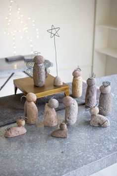 some rocks are sitting on a table and one is made to look like people holding hands