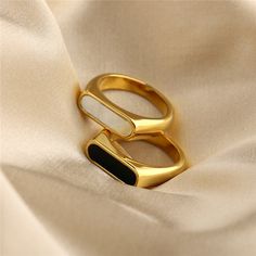 This elegant gold ring is a stunning piece of jewelry that is sure to impress.✨ Made from high-quality material, the ring has a sleek and sophisticated design that exudes style and refinement. The gold has a beautiful shine that catches the light and adds a touch of glamour to any outfit. Whether you choose a classic black or the white, this ring is sure to make a statement. Perfect for any special occasion, whether you're dressing up for a formal event or just want to add a touch of elegance to your everyday look! It's the perfect gift for someone special or a luxurious treat for yourself. Whether you're looking for a statement piece or a timeless classic, this elegant gold ring is sure to exceed your expectations. Size circumference: 5:    49.3 mm 6:    51.9 mm 7:    54.4 mm 8:    57 mm Baby Rings, Precious Rings, Bar Ring, Shell Ring, Ringe Gold, Silver Jewelry Necklace, Golden Ring, Chunky Rings, Waterproof Jewelry