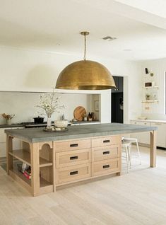 a large kitchen with an island in the middle