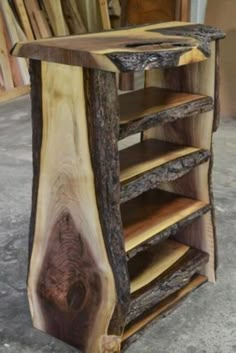 a wooden shelf with several shelves made out of tree trunks and wood veneers