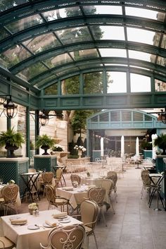 an indoor dining area with tables and chairs