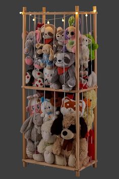 a wooden shelf filled with lots of stuffed animals and lights on top of each shelf