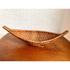 a woven basket sitting on top of a wooden table