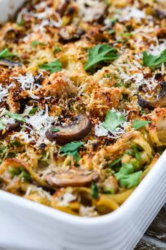 a casserole dish with mushrooms, spinach and parmesan cheese