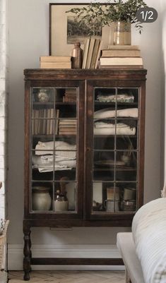 a room with a bookcase and a bed in it, next to a fireplace