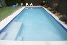 an empty swimming pool in the middle of a backyard