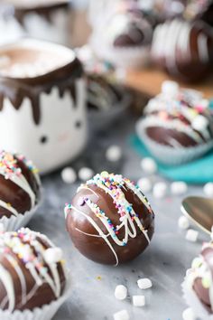 chocolate covered donuts with sprinkles on a table