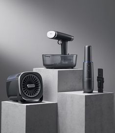 an assortment of electronic devices sitting on top of cement blocks in front of a gray background