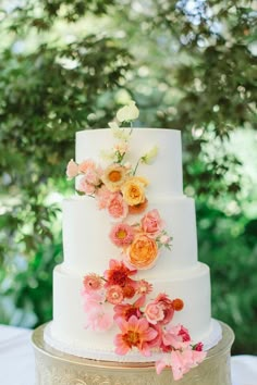 a white wedding cake with flowers on top