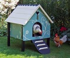 there is a bird that is sitting in the blue and white birdhouse on the grass