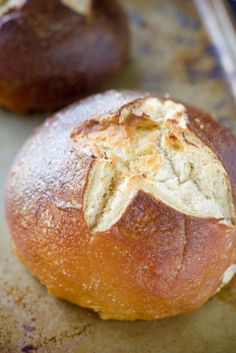 two loaves of bread sitting on top of a baking sheet