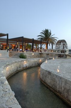 an outdoor area with lights and water