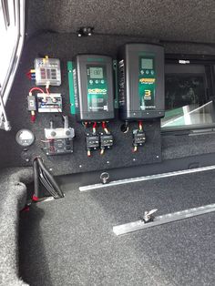 the inside of a car with three batteries and other electronics