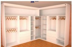 an empty white closet with wooden flooring