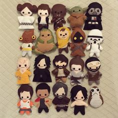 star wars plush toys laid out on a bed