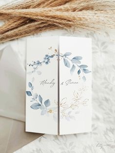 two cards with blue leaves on them sitting next to twine of twine rope