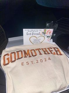 a white blanket with the word godmoted on it sitting next to a card