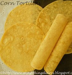 two corn tortillas on a plate next to each other with the word corn tortilla written below it