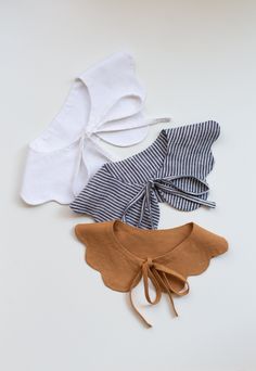 three pieces of cloth tied together on a white surface