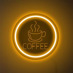 a neon sign with a coffee cup on it's side and the word coffee written below