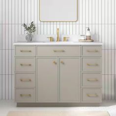 a bathroom vanity with two sinks and a mirror above it, in front of a striped wall