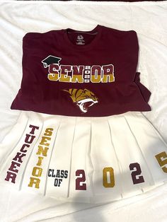 Show off your school spirit in style with our Class of 2025 two-piece set! 🎓✨ This look is perfect for seniors ready to own their year. With a bold graphic tee and a custom pleated skirt featuring your school and class, you'll be turning heads at every senior event. Grab yours now and rep your class with pride! 🔥 #SeniorSeason #ClassOf2025 *Color Options: Choose from a range of vibrant colors to match your school's theme or your personal style, making sure you stand out while cheering your heart out. *Personalized Text: Add your name, graduation year, or a your schools logo for an extra personal touch. *Design Placement: Customize where you want your photo and text to appear -- whether it's front and center, on the back, or along the sleeves for added flair. Senior Shirt Designs, Senior Shirt Ideas, Senior Year Quotes, Decatur Ga, Senior Shirts, Class Of 2025, Graduation Year, Graduation Diy, School Logo