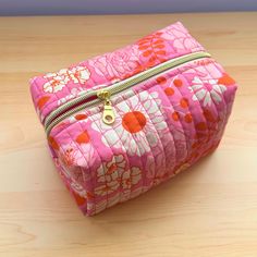 This beautifully handmade quilted makeup bag is the perfect blend of style, durability, and functionality! Crafted with care from high-quality fabrics, this cosmetic bag features a unique quilted design that adds both texture and charm. The spacious interior is fully lined in light pink fabric, providing ample space for all your beauty essentials, while the sturdy zipper closure ensures everything stays secure. Whether you're organizing makeup, skincare, or travel toiletries, this bag is versatile enough to handle it all. Compact enough to slip into your purse or travel bag, it's the ideal companion for those on the go. Each makeup bag is individually sewn, making it a one-of-a-kind gift for yourself or a loved one. **Features - Handmade with love using premium fabrics - Quilted design for Organizing Makeup, Quilted Makeup Bag, Light Pink Fabric, Everything Stays, Travel Toiletries, Toiletry Storage, Makeup Skincare, Gold Zipper, Pink Fabric