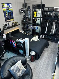 a room filled with lots of black furniture and items on the walls, including a bed