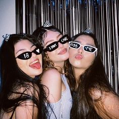 three young women with their mouths open and wearing sunglasses that say love is the key