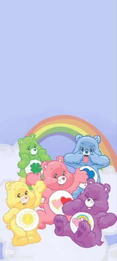 a group of teddy bears sitting next to each other in front of a rainbow and blue sky