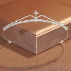 a diamond tiara sits on top of a box