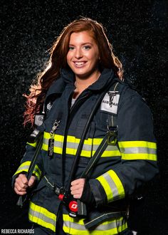 a woman in a firefighter's uniform posing for a photo