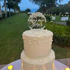 a three tiered wedding cake sitting on top of a table