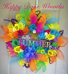 a colorful wreath with the words happy dog treats on it and flowers in front of an open door