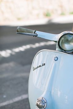 an old scooter is parked on the side of the road