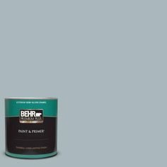 a can of behr paint on a grey background