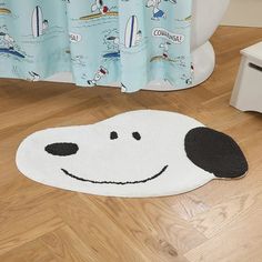 a bathroom rug with a cartoon dog on it