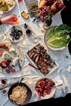 a table topped with plates and bowls filled with food