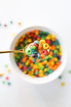 a spoon full of cereal with colorful cereal in it