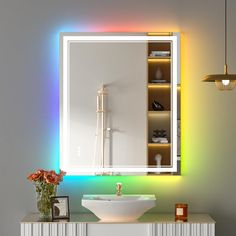 a white sink sitting under a bathroom mirror next to a wall mounted faucet