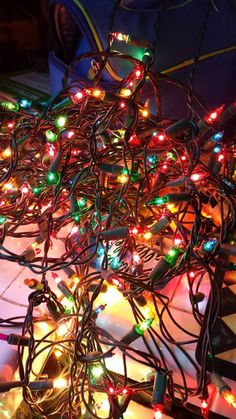 a pile of christmas lights sitting on top of a table