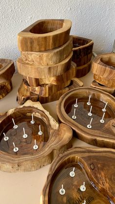 several wooden bowls are stacked on top of each other and have small holes in them