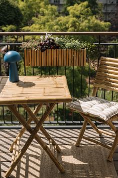 two chairs and a table on a balcony