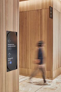 a blurry image of a person walking past a wooden sauna