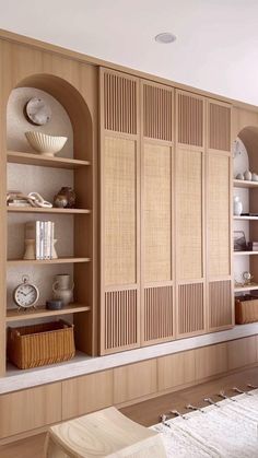 a living room filled with lots of furniture and wooden shelves next to a wall mounted clock