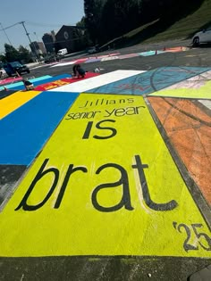 a colorful parking lot that has been painted with the words is bratt on it