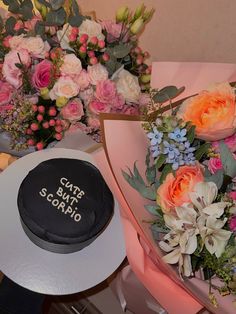 there is a cake and flowers on the table