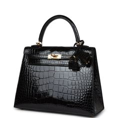 This Sellier Kelly is in Black shiny Mississippiensis alligator with gold hardware and has tonal stitching, front flap, two straps with center toggle closure, clochette with lock and two keys, single rolled handle and removable strap.The interior is lined with black chevre and has a zip pocket with an Hermes engraved zipper pull and two open pockets on the opposite side. Collection: ZOrigin: FranceCondition: New and never worn (Plastic on hardware)Accompanied by: Hermes box, Hermes dustbag, cloc Classic Luxury Alligator Leather Bags, Luxury Black Bags With Ykk Zipper, Designer Luxury Shoulder Bag With Lock, Luxury Formal Shoulder Bag With Cc Turnlock, Luxury Designer Shoulder Bag With Lock, Luxury Black Bag With Shoe Compartment, Luxury Formal Bags With Horsebit Detail, Hermes Kelly Handbags, Hermes Bag Women