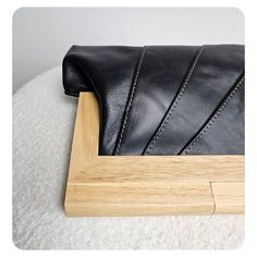 The combination of leather and timber in these clutches indeed creates a beautiful and harmonious design. The clutches are made with exquisite, smooth, and high-quality leather sourced from New Zealand. The use of this premium leather ensures durability and a luxurious feel to the touch, enhancing the overall aesthetic of the clutch. The natural timber handle not only adds a unique and organic element but also provides a functional magnetic closure to securely keep the contents of your purse safe. The magnetic closure ensures easy access while providing peace of mind that your belongings are secure. To add further interest, the clutches are lined with printed cotton lining. Please note that the actual lining may vary from the picture, adding a delightful surprise and making each clutch uni Black Leather Clutch With Leather Lining, Modern Leather Clutch With Smooth Grain, Modern Rectangular Clutch With Leather Lining, Chic Rectangular Clutch With Leather Lining, Modern Leather Clutch With Soft Leather, Modern Clutch In Soft Leather, Modern Soft Leather Clutch, Rectangular Textured Leather Clutch, Leather Evening Clutch With Leather Handles