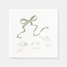 a white card with green ribbon and two cartoon characters